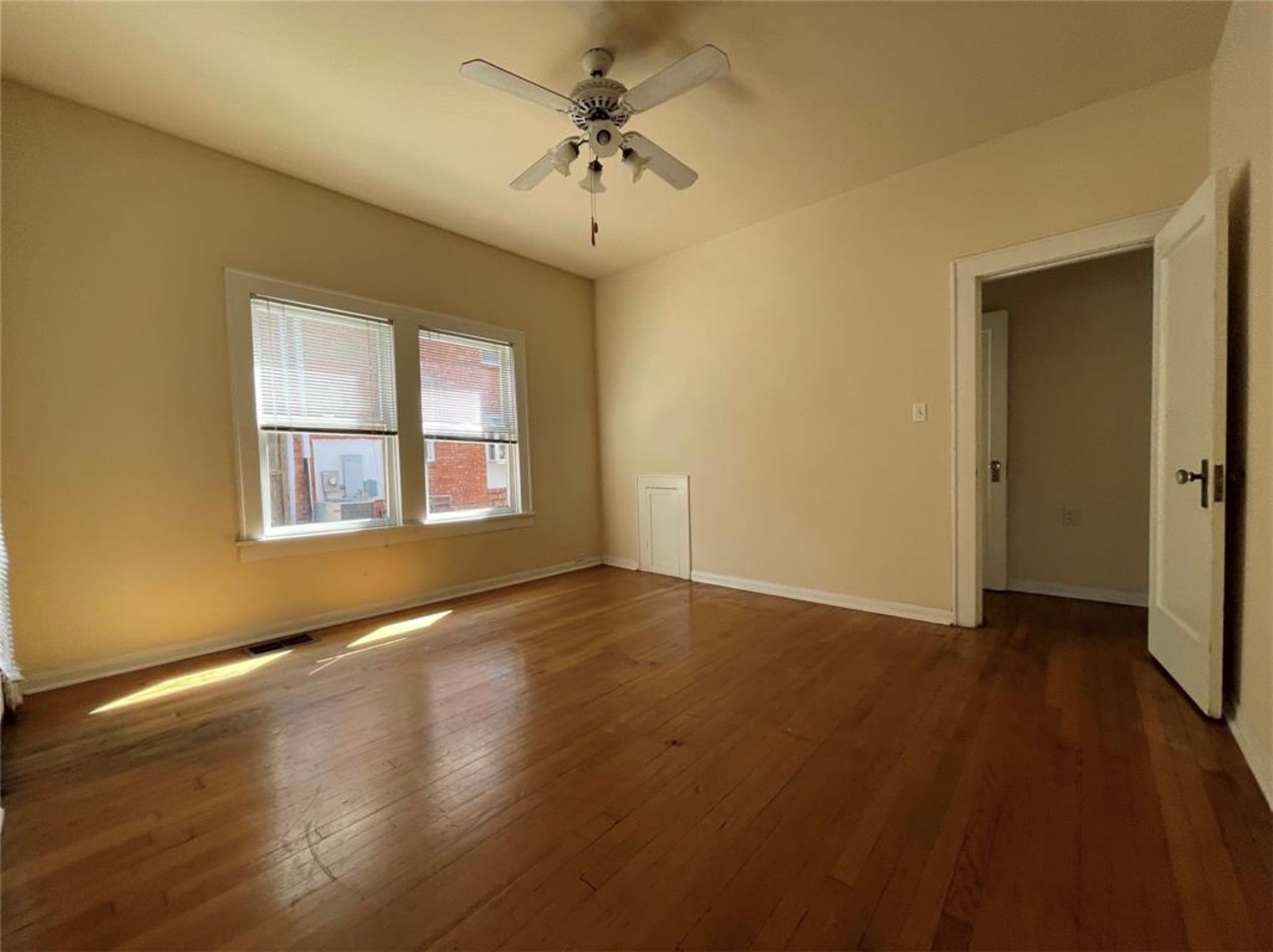 1706 Hawthorne Street Houston, TX 77098 - Photo 5 of 25 a view of an empty room with a window and wooden floor