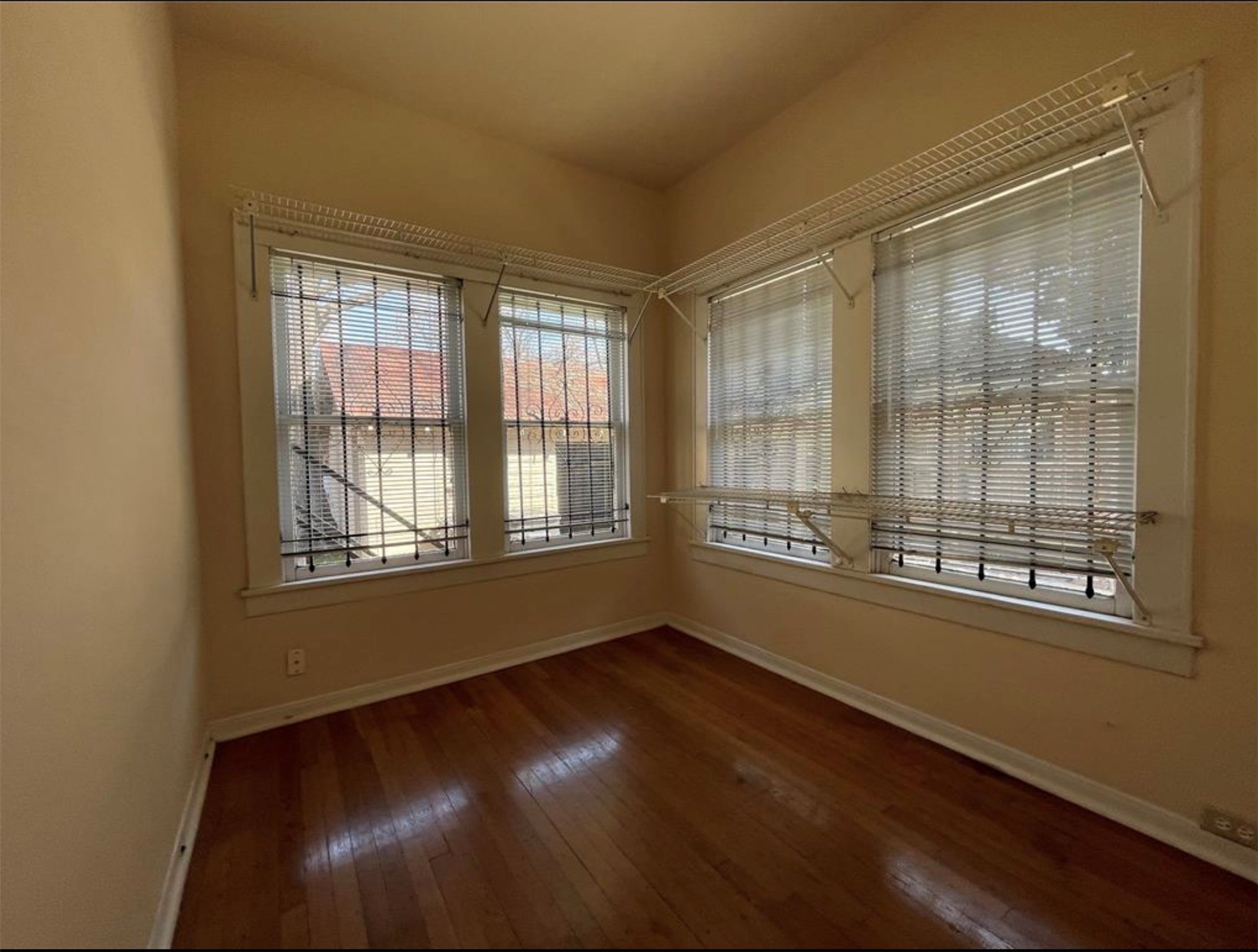 1706 Hawthorne Street Houston, TX 77098 - Photo 6 of 25 a view of an empty room with wooden floor and a window