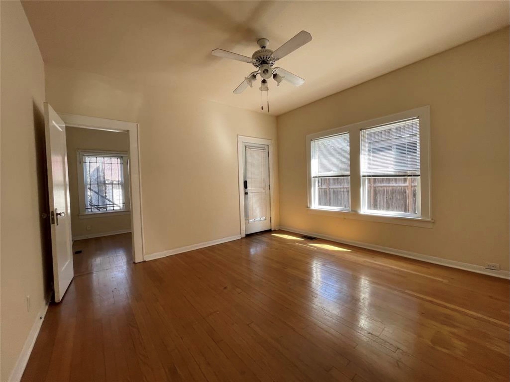 1706 Hawthorne Street Houston, TX 77098 - Photo 7 of 25 a view of an empty room with wooden floor and a window