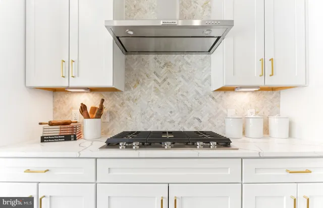 a kitchen with stove and cabinets