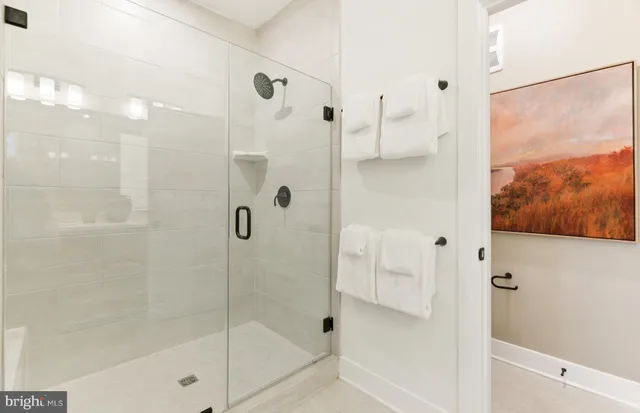 a bathroom with a tub sink double vanity and a mirror