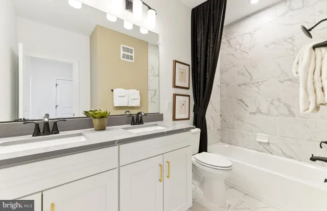 a bedroom with a bed and a lamp on the dresser