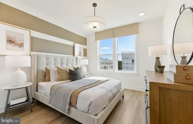 a bathroom with a granite countertop sink mirror vanity bathtub and a toilet