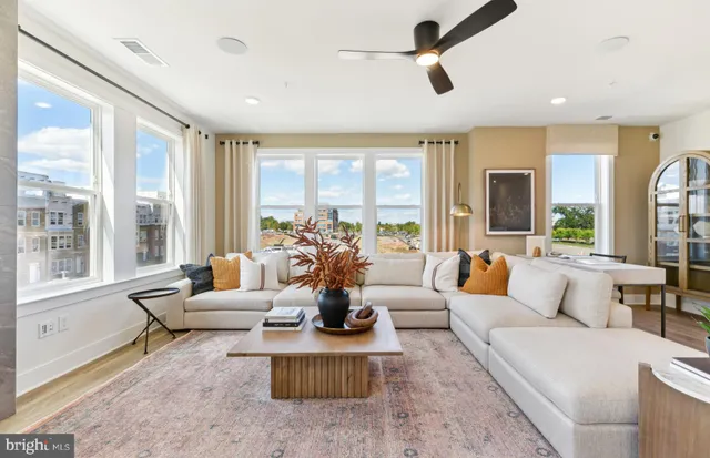 a living room with furniture and a large window