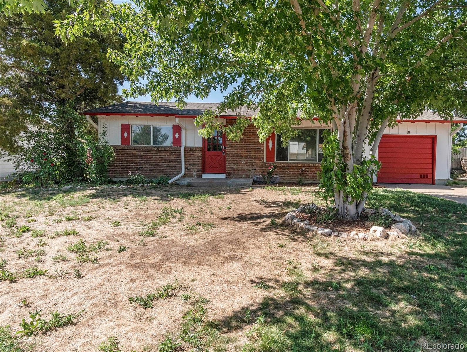 3416 West 5th St Road Greeley, CO 80634 - Photo 1 of 18 a front view of a house with garden