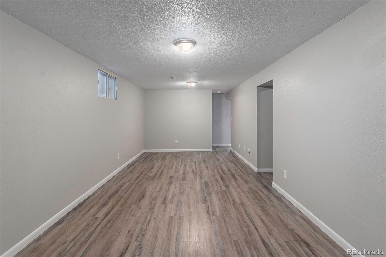 3416 West 5th St Road Greeley, CO 80634 - Photo 14 of 18 a view of a room with wooden floor and white walls