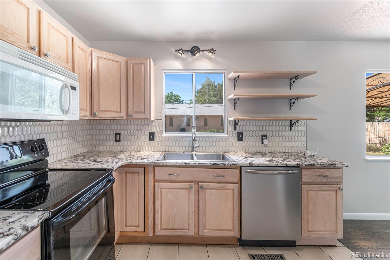 3416 West 5th St Road Greeley, CO 80634 - Photo 8 of 18 a kitchen with stainless steel appliances granite countertop a sink stove and cabinets