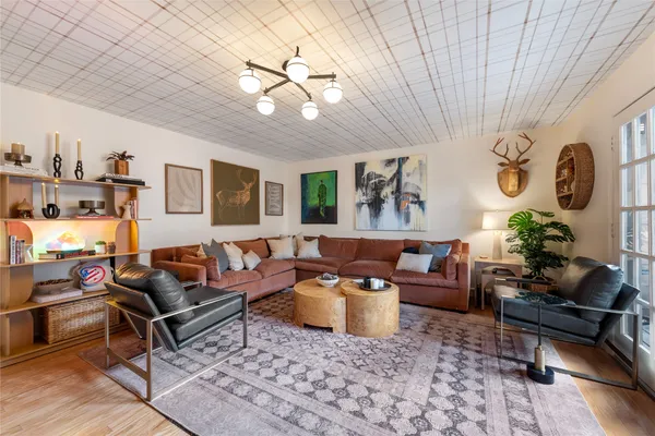 a living room with furniture and wooden floor