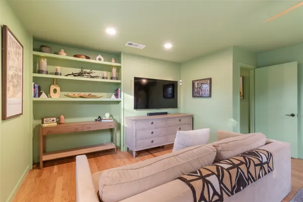 a bedroom with a bed and flat screen tv