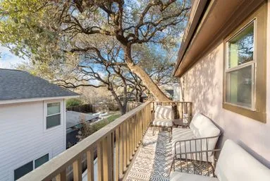a view of a balcony with wooden fence and floor