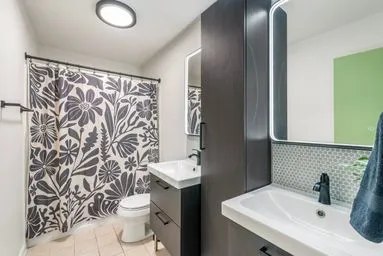a bathroom with a sink toilet and shower