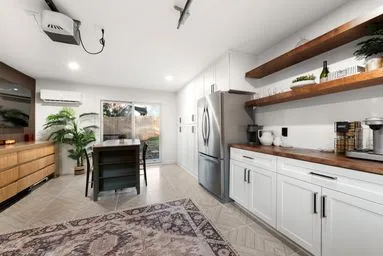 a kitchen with stainless steel appliances kitchen island granite countertop a refrigerator and a sink
