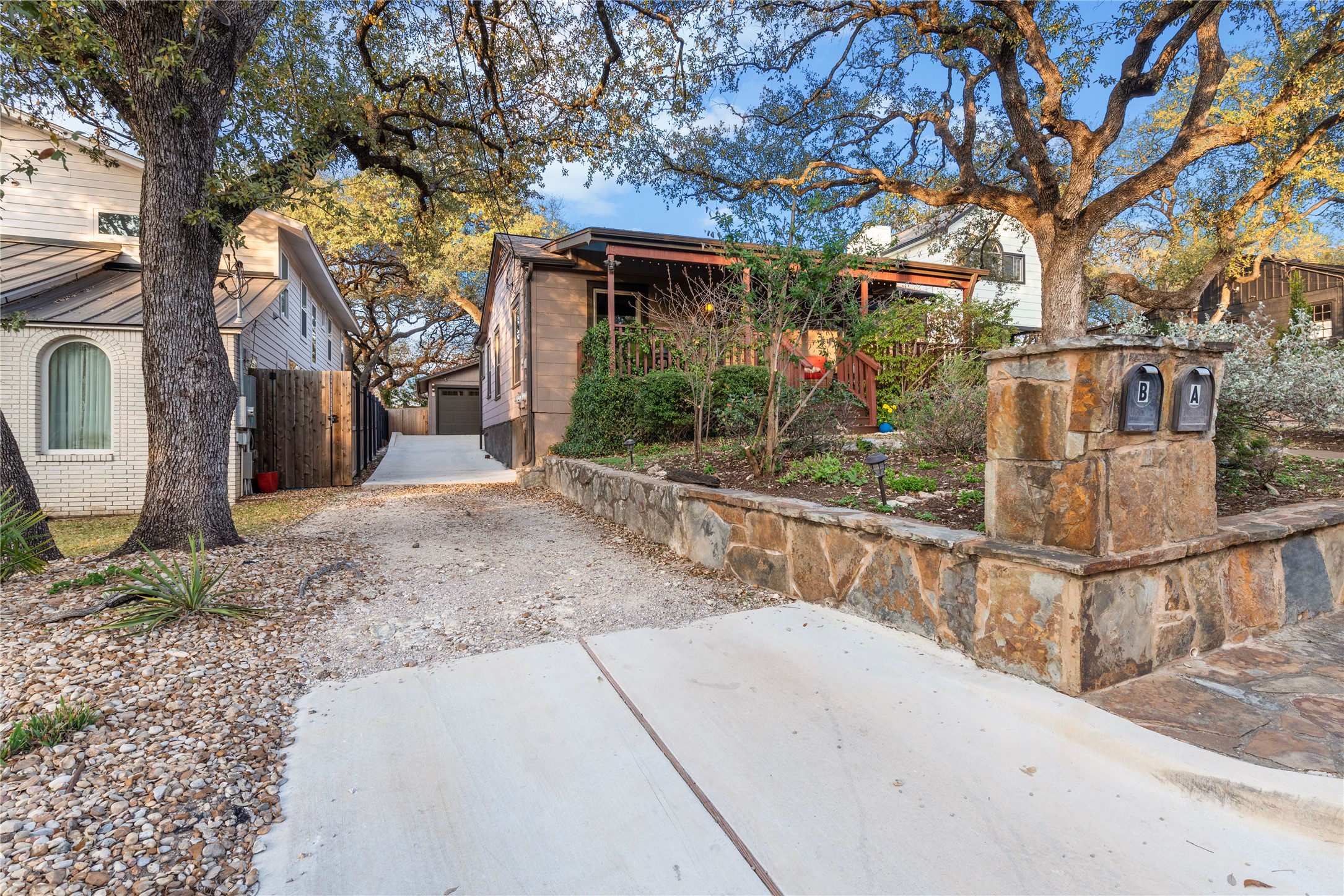 1106 Mission Ridge, Unit B Austin, TX 78704 - Photo 2 of 27 a view of a house with large tree and wooden fence