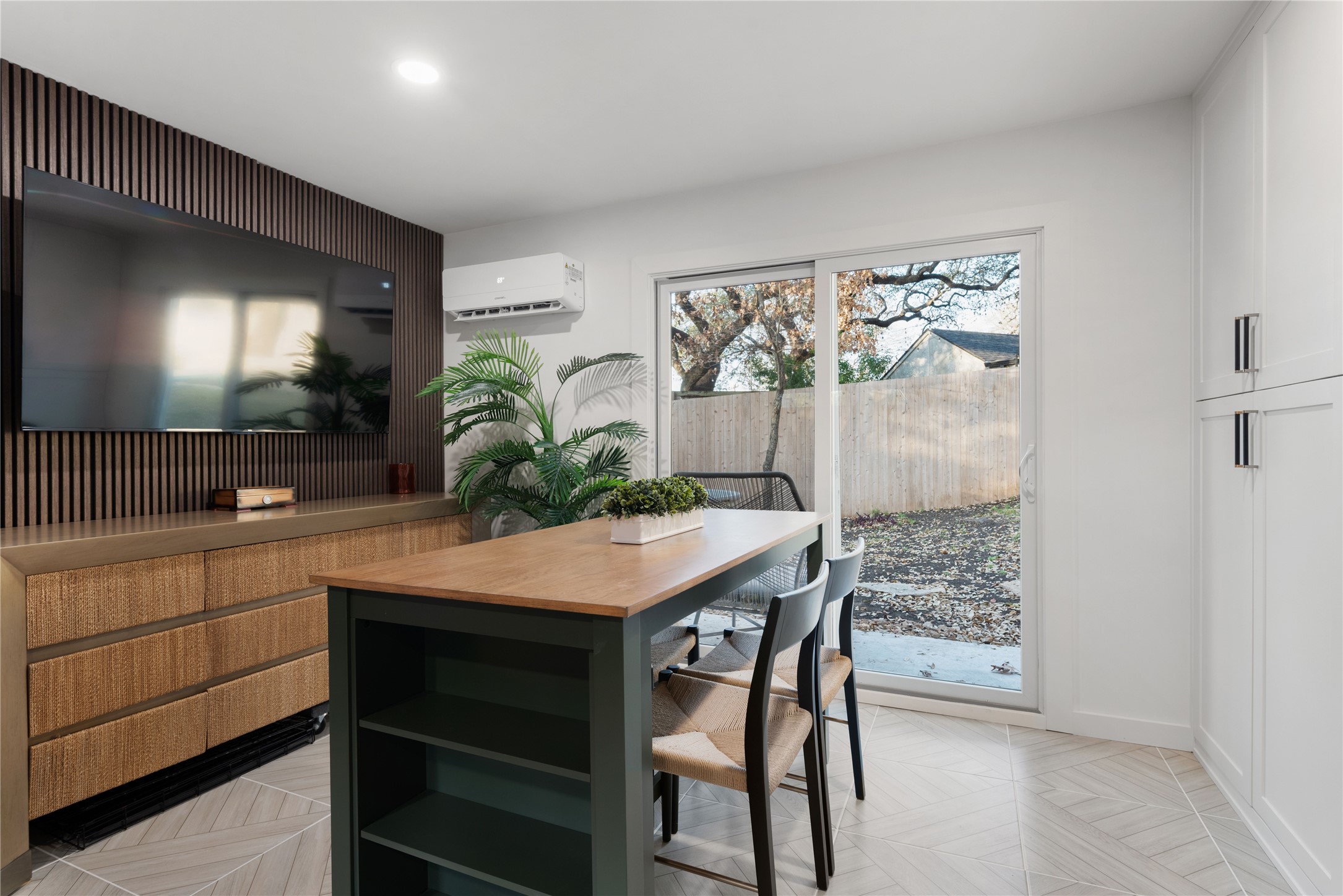 1106 Mission Ridge, Unit B Austin, TX 78704 - Photo 21 of 27 a kitchen with stainless steel appliances kitchen island a table and chairs in it
