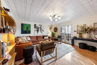 a living room with furniture a fireplace and a chandelier