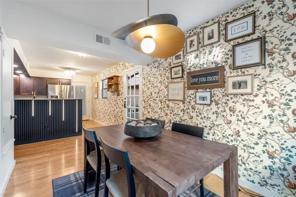 a dining room with furniture and wooden floor