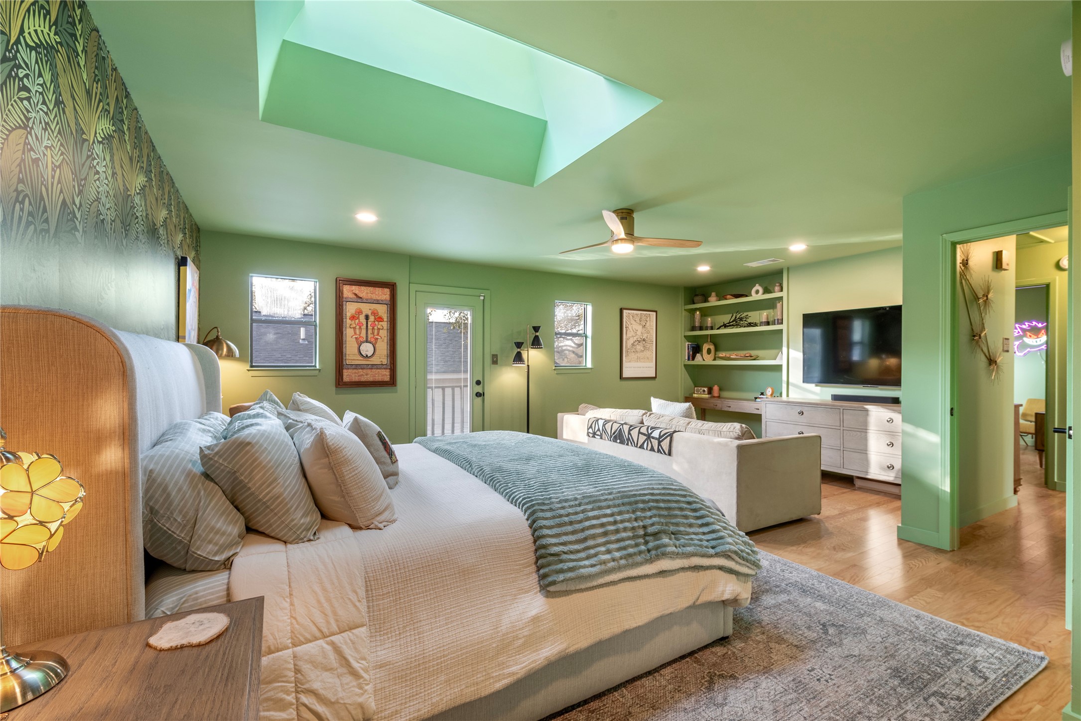 1106 Mission Ridge, Unit B Austin, TX 78704 - Photo 10 of 27 a large bedroom with a bed and wooden floor