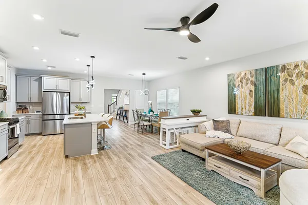 a living room with furniture and kitchen view