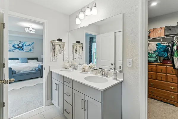 a en suite bathroom with a sink double vanity and a mirror