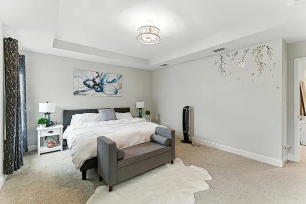 a bedroom with a bed and a chandelier