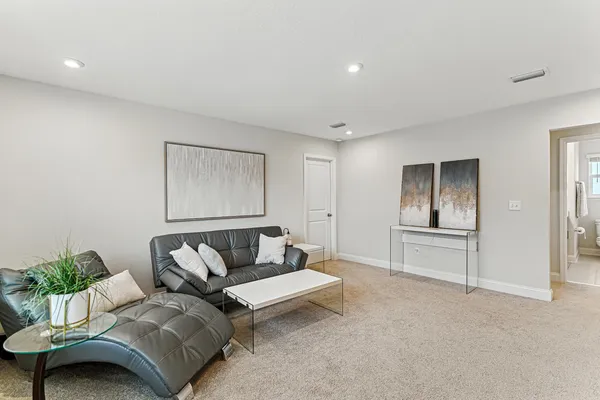a living room with furniture and a potted plant