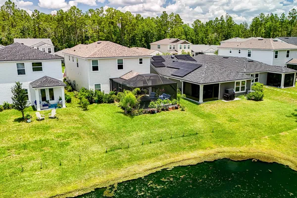 a aerial view of a house with swimming pool and green space