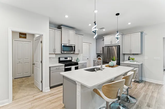 a kitchen that has a lot of counter space and wooden floor
