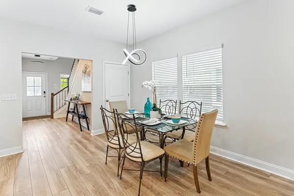 a view of a dining room with furniture window and wooden floor