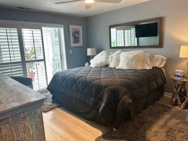 4396 Baldwin Avenue, Unit 82 Little River, SC 29566 - Photo 11 of 31 Bedroom with access to outside, wood finished floors, multiple windows, and ceiling fan