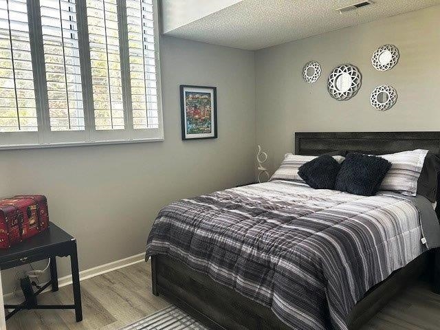 4396 Baldwin Avenue, Unit 82 Little River, SC 29566 - Photo 17 of 31 Bedroom with wood finished floors and a textured ceiling