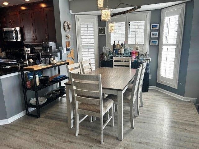 4396 Baldwin Avenue, Unit 82 Little River, SC 29566 - Photo 7 of 31 Dining space with light wood finished floors and a chandelier