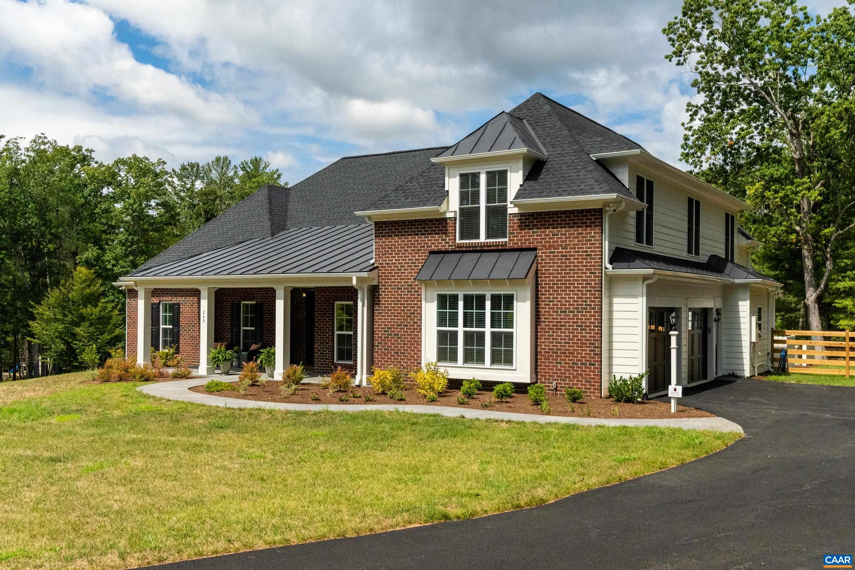 240 Campbell Road Keswick, VA 22947 - Photo 1 of 68 a front view of a house with a yard table and chairs