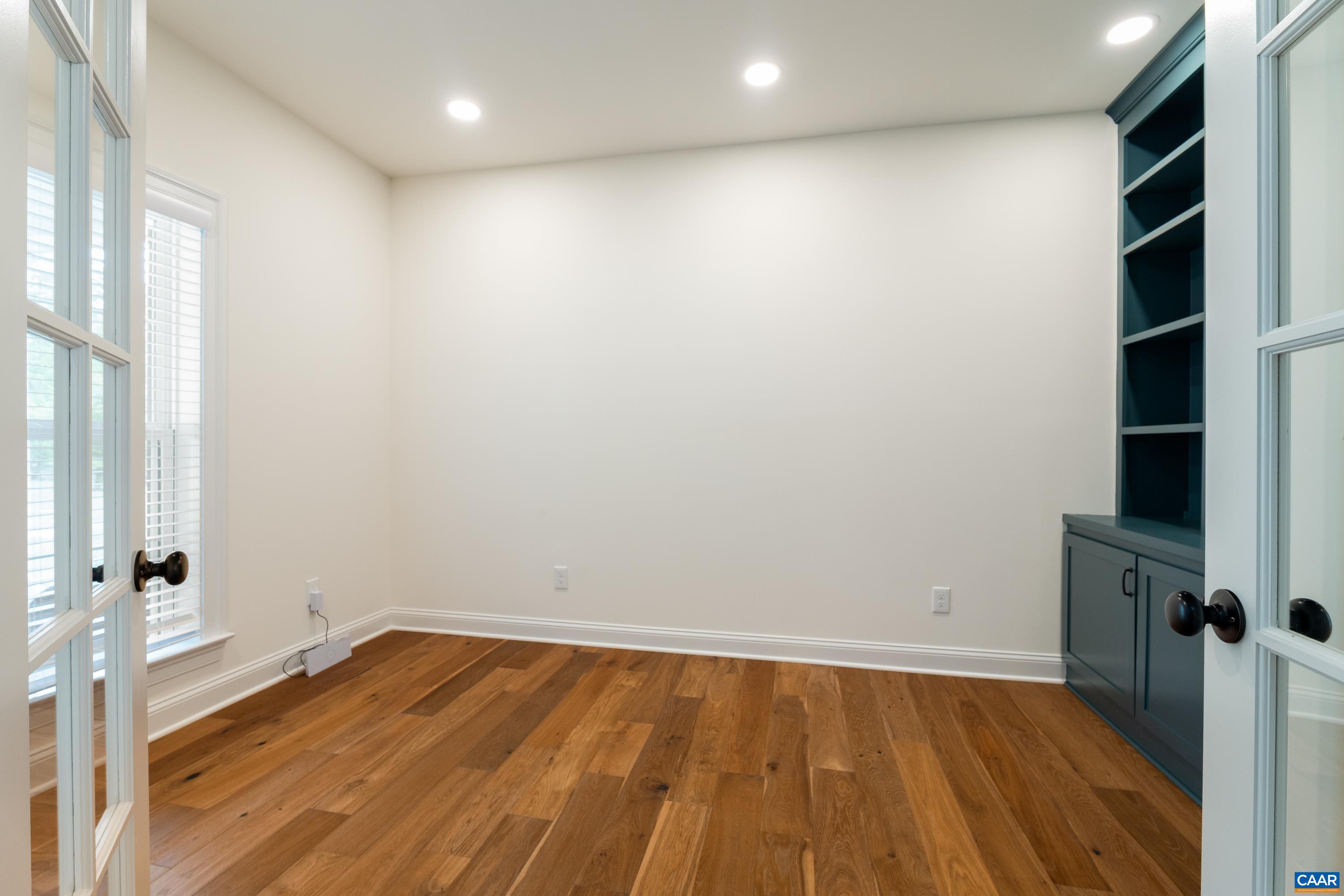 240 Campbell Road Keswick, VA 22947 - Photo 15 of 68 a view of an empty room with wooden floor and a window
