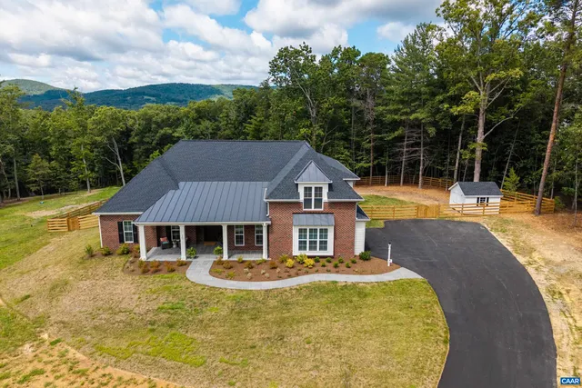 a house with swimming pool in front of it