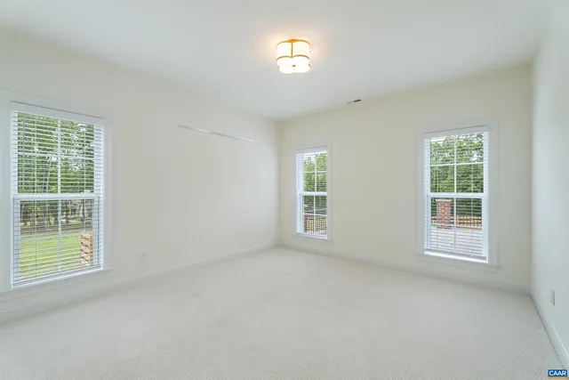 a view of a big room with closet and windows