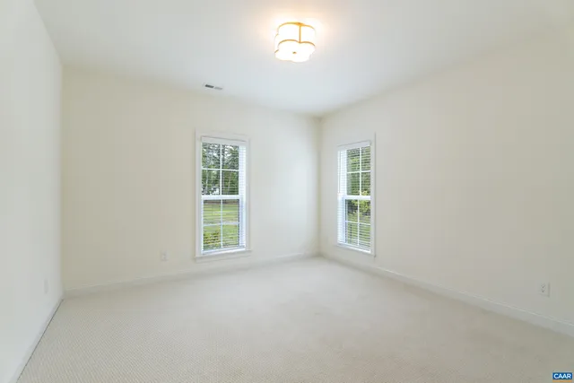 a view of a house with yard and sitting area