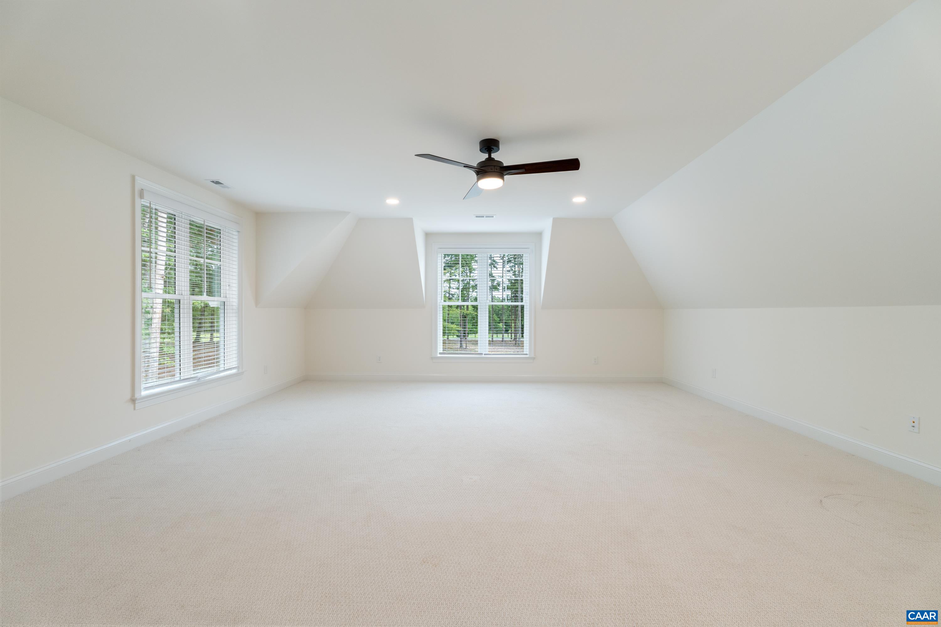 240 Campbell Road Keswick, VA 22947 - Photo 49 of 68 an empty room with windows and chandelier fan