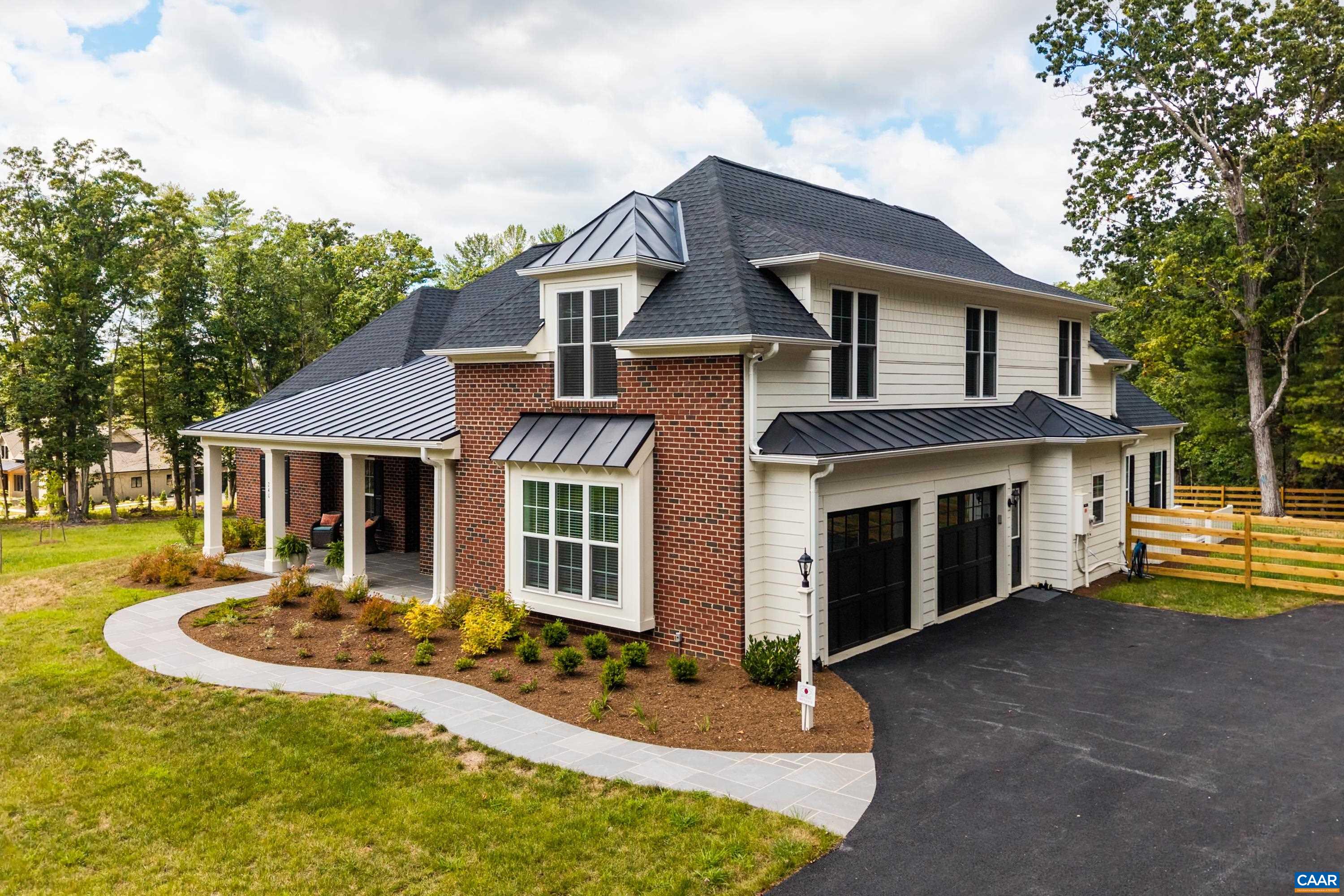 240 Campbell Road Keswick, VA 22947 - Photo 7 of 68 a front view of a house with a yard table and chairs