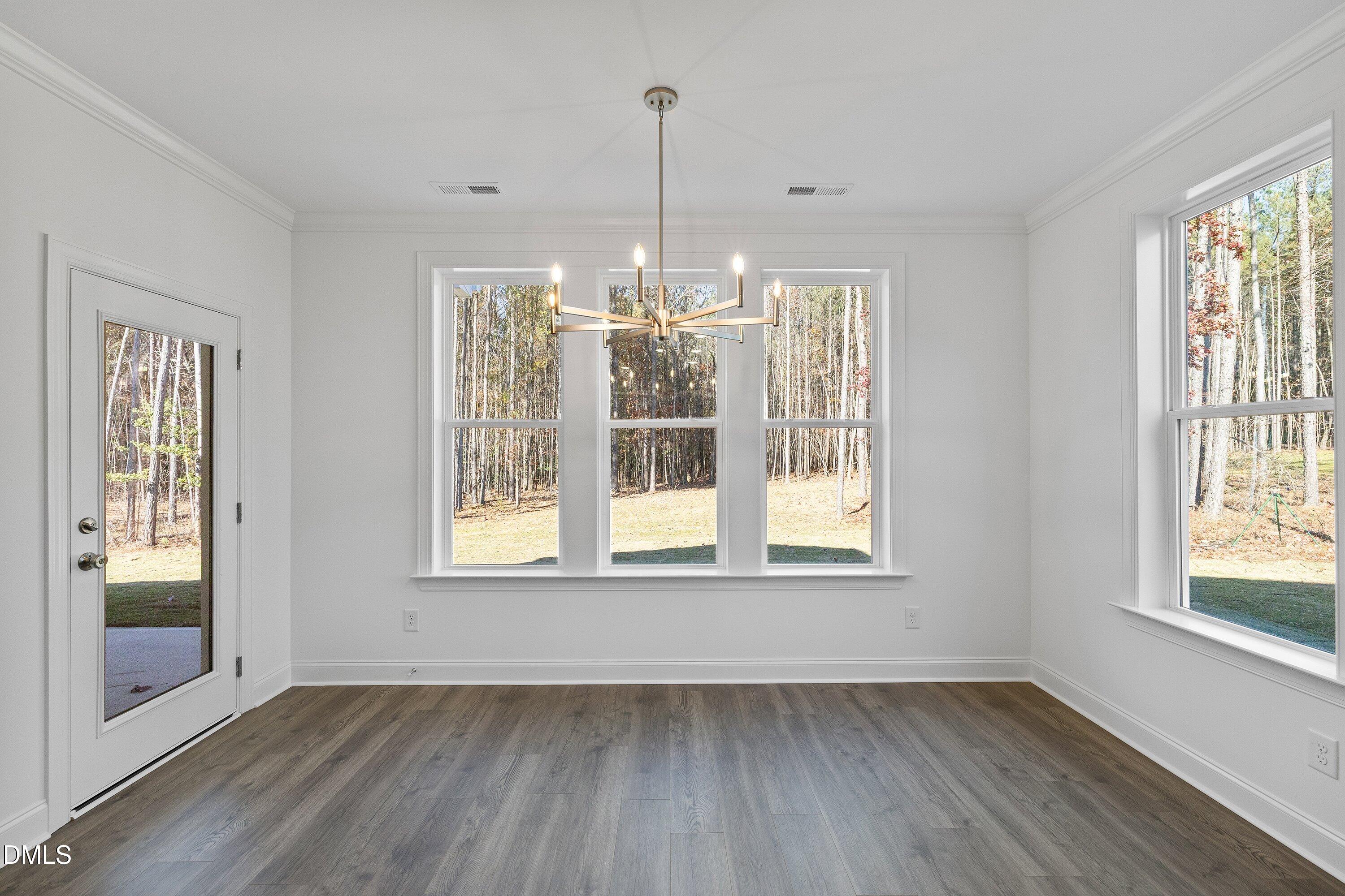 62 West Victoria Ridge Drive, Unit 19 Selma, NC 27576 - Photo 8 of 26 a view of an empty room with wooden floor and a window
