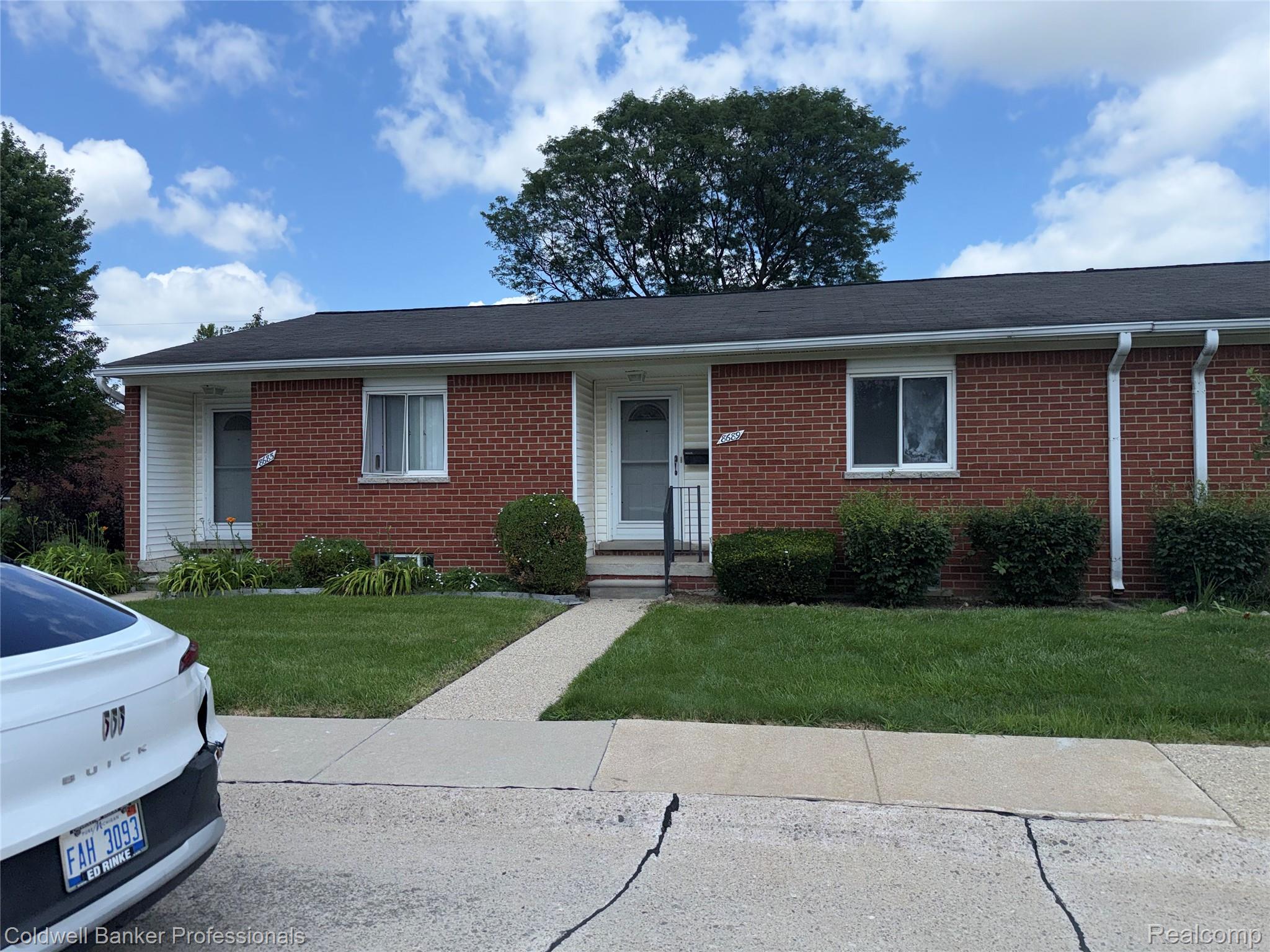8689 Sterling Street Center Line, MI 48015 - Photo 1 of 24 Brick and white siding exterior with dark shingle roof