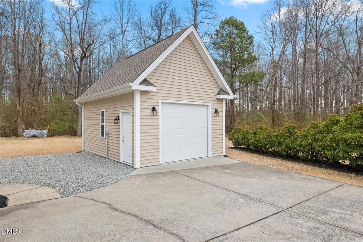 2000 Castana Court Willow Spring, NC 27592 - Photo 17 of 20 a view of house with a yard and garage