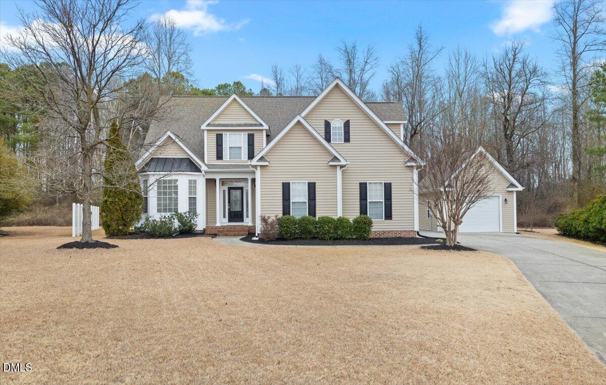 2000 Castana Court Willow Spring, NC 27592 - Photo 18 of 20 a front view of a house with a yard and garage