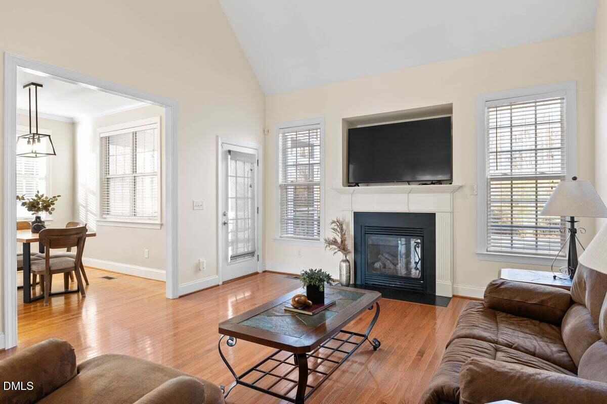 2000 Castana Court Willow Spring, NC 27592 - Photo 6 of 20 a living room with furniture a flat screen tv and a fireplace
