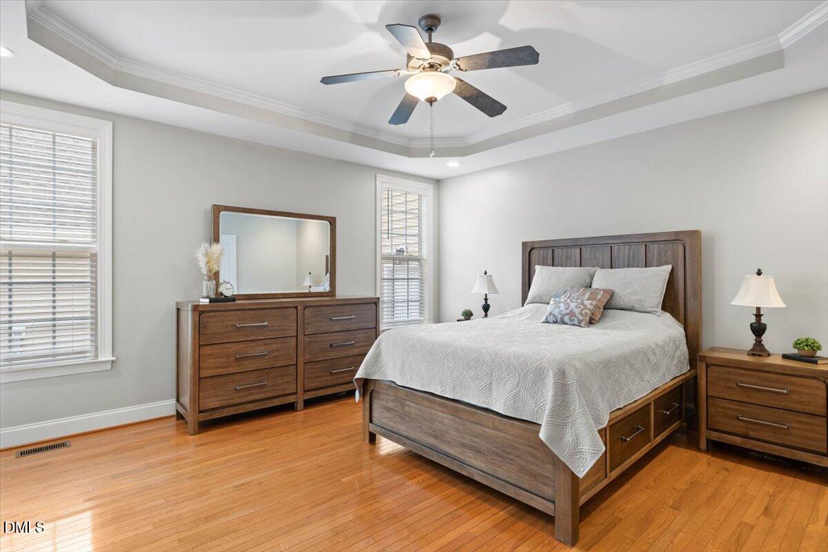 2000 Castana Court Willow Spring, NC 27592 - Photo 8 of 20 a bedroom with a bed and a chandelier