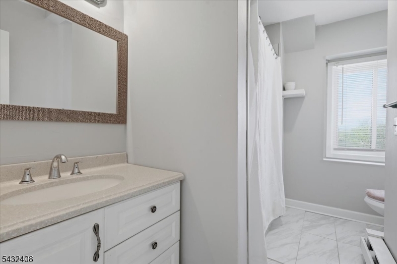 112 Knob Hill Road Hackettstown, NJ 07840 - Photo 29 of 32 a bathroom with a sink a toilet and a mirror
