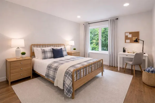 a spacious bedroom with a bed and a window