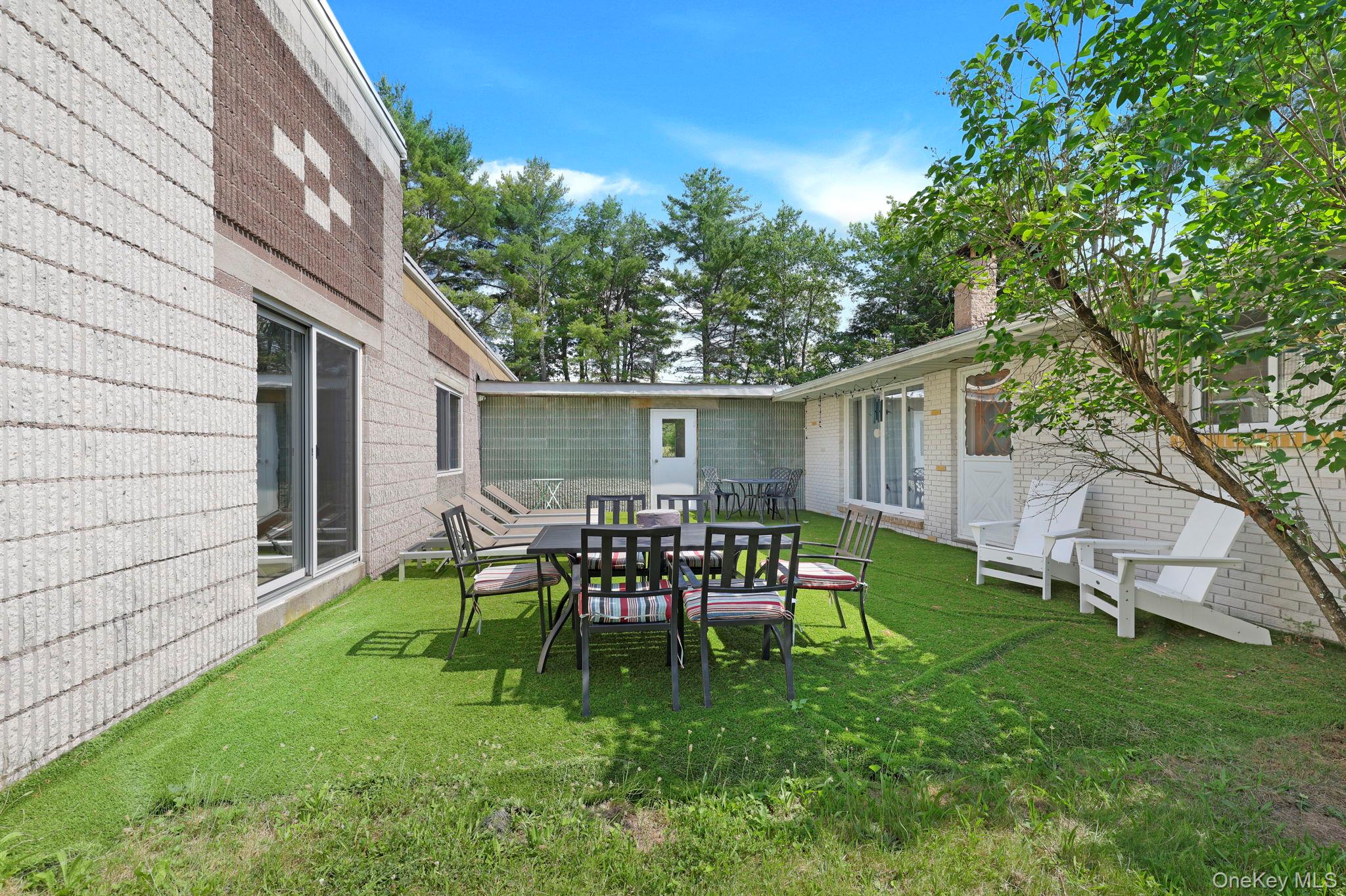35 Kroeger Road Monticello, NY 12701 - Photo 26 of 29 a view of a backyard with table and chairs and a tree