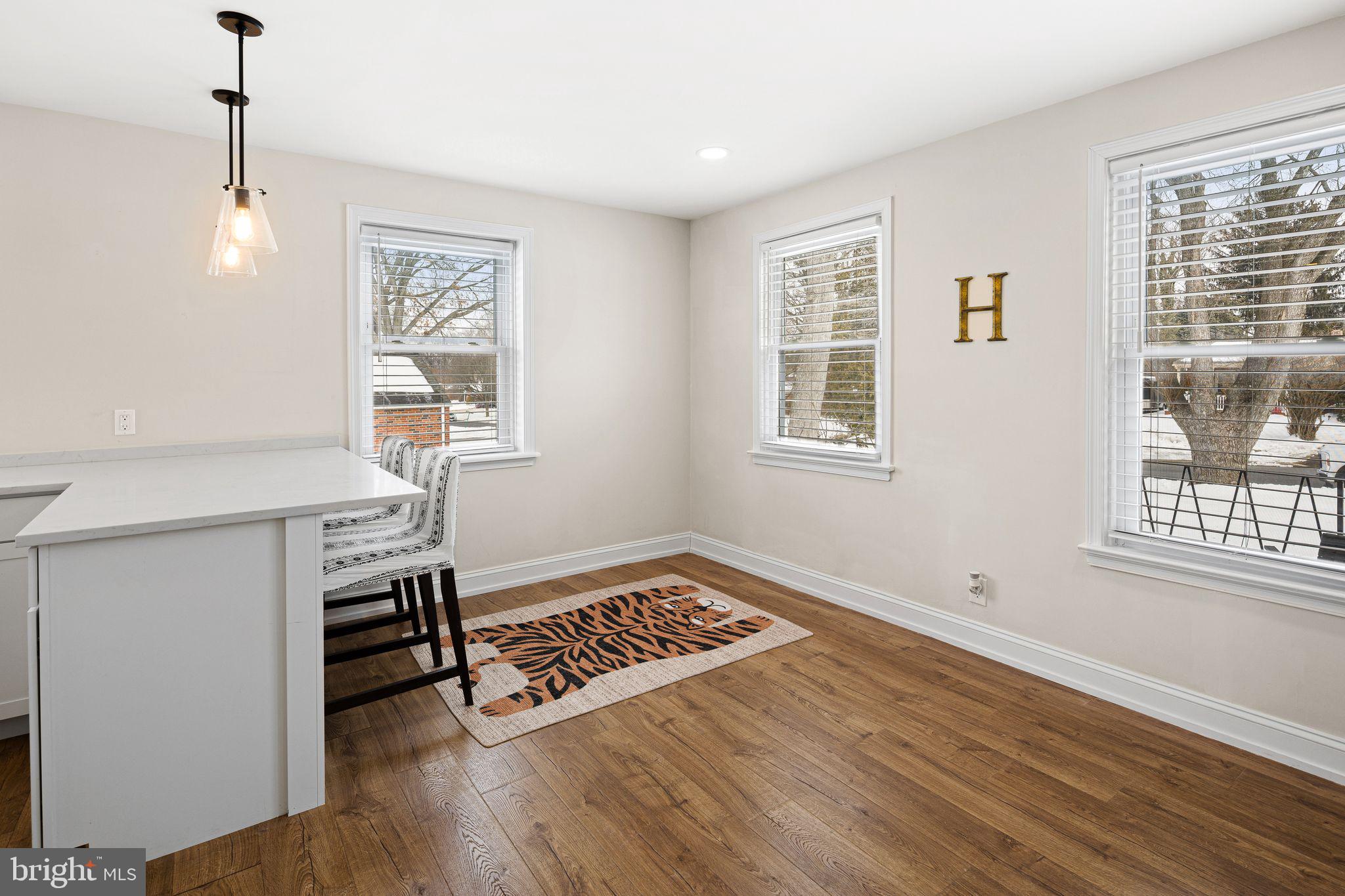 910 Edann Road Oreland, PA 19075 - Photo 12 of 26 a view of an empty room with a window and wooden floor