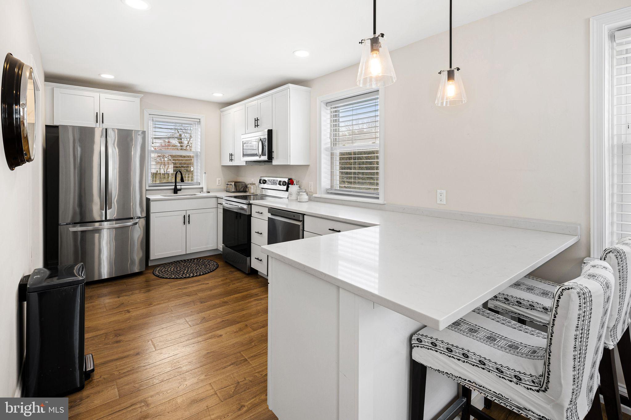 910 Edann Road Oreland, PA 19075 - Photo 14 of 26 a kitchen with stainless steel appliances granite countertop a refrigerator a stove a sink dishwasher and a refrigerator