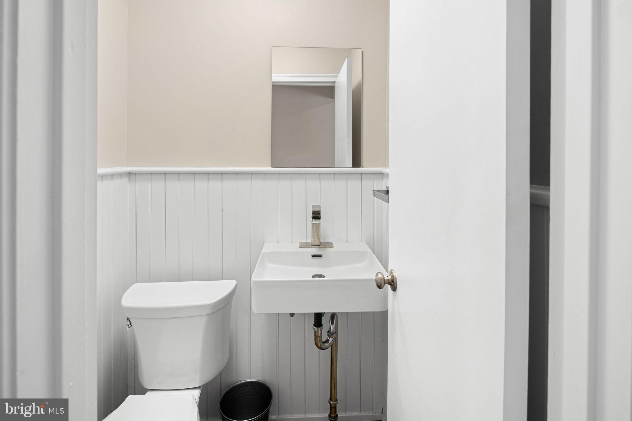 910 Edann Road Oreland, PA 19075 - Photo 17 of 26 a bathroom with a sink toilet and mirror